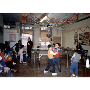 Guests play during the Chinese Progressive Association's children's party