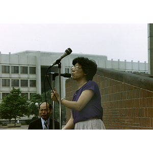 Chinese Progressive Association director Suzanne Lee, facing left, speaking at a rally for Long Guang Huang at City Hall Plaza in Boston