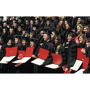 School of Law graduates posing with their diplomas at the commencement ceremony for the Class of 1997