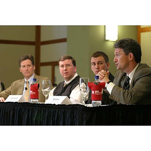 Bob Davis speaks next to three other men at the Training Future Innovators Entrepreneurs Panel