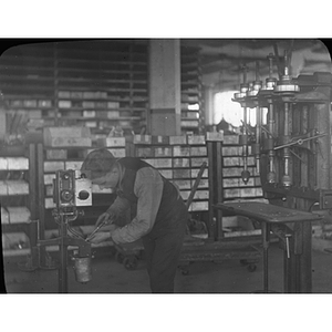 A mechanical engineering student assembles machines at the United Shoe Machinery Corporation in Beverly