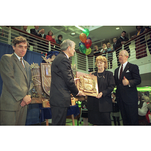 John and Marcia Curry hold a plaque at the dedication of the Curry Student Center