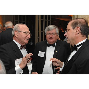 President Aoun speaking with two guests at the Huntington Society Dinner