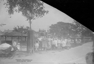 Full-length group portrait of children standing in Gibson Playground, Dorchester, Mass., undated