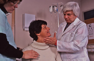 Delores Krieger with hand on patient's throat