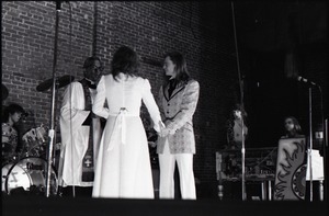 Wedding of Jim and Anne Baker: exchanging vows in front of minister and drum set