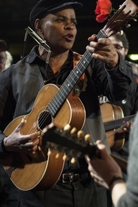 Guy Davis playing guitar during the Earth Day Concert in Tarrytown