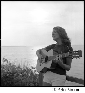 Lucy Simon, playing guitar by the sea