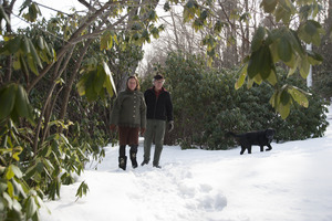 Couple and their dog walking through the snow at Naulakha, Rudyard Kipling's home from 1893-1896