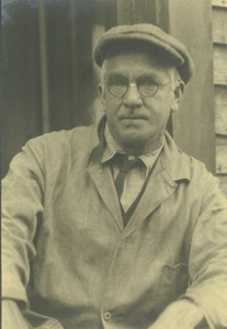Michael Connor sitting outdoors, leaning against building