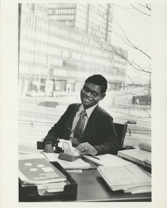 Man in a wheelchair seated at a desk