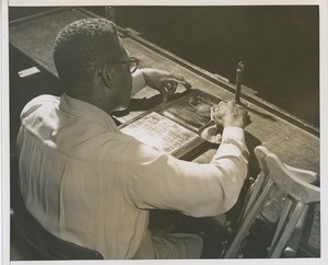 A man polishes the 1955 President's Committee on Employment of the Physically Handicapped Award