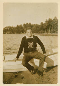 A young Charles E. Silvia sitting on boat