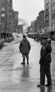 Unidentified officer, Military Police officer, and military vehicles