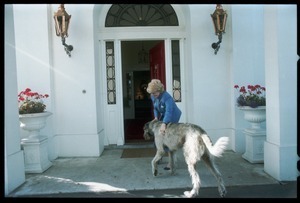 Margaret Heckler, United States Ambassador to Ireland, at the door of her residence, greeting her Irish wolfhound, Jackson O'Toole