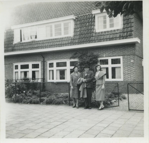 W. E. B. Du Bois, Shirley Graham Du Bois and an unidentified woman standing in front of a house