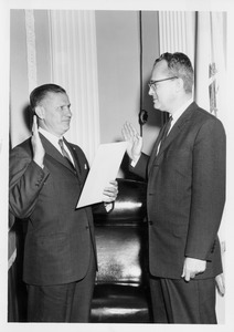 John W. Lederle being sworn in as University president by unidentified man