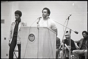 Huey P. Newton speaking at Boston College: Newton at the podium, David Hilliard at far right