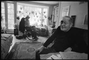 W. Eugene Smith, seated at a desk in his home