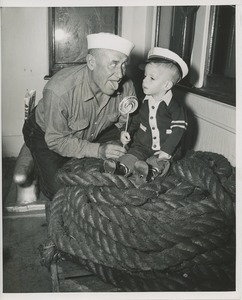 Disabled boy with lollipop on boat