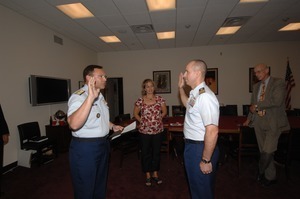 Commander Mark Fedor (2d from right), US Coast Guard, being sworn in as Special Detailee to House Appropriations Committee, Congressman John W. Olver (far right) in background