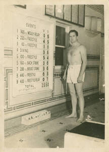 Springfield College Swimmer standing next to scoreboard