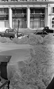 Snowdrifts and cars on Berkeley and Stuart Streets