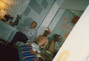A Photograph of Marsha P. Johnson Sitting Next to Randy Wicker at Her Birthday Party