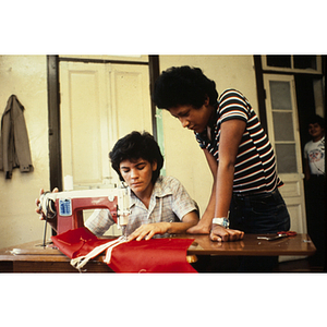 Two people working at a sewing machine