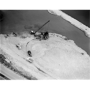 Western suburb or South road construction, crane and trucks, close up, near water, unidentified