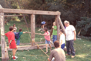 HMF Fall Fest 1998 3. Post-and-beam demonstration by Richard Babcock (left in white tee-shirt) at the "bull wheel" winch attached to a "gin pole".