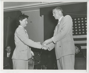 Unidentified man and woman shaking hands at Institute Day