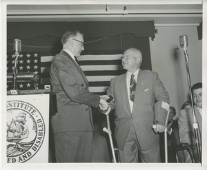 Unidentified man shaking hands with client at Institute Day