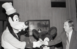 Man with Disney characters Mickey Mouse and Goofy