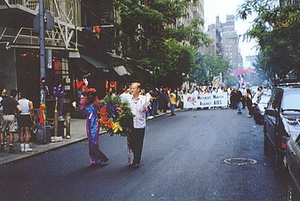 A Photograph of Cocoa Rodriguez Carrying a Floral Wreath in a Parade