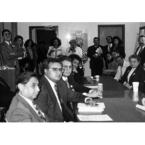 Men and women in the Inquilinos Boricuas en Acción offices listening to Edward Kennedy.