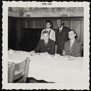 Three men and a boy pose for a group picture at a Boys' Club Inaugural Dinner