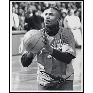 Former New England Patriot Ronnie Lippett holding a basketball and standing in shooting position at a fund-raising event held by the Boys and Girls Clubs of Boston and Boston Celtics