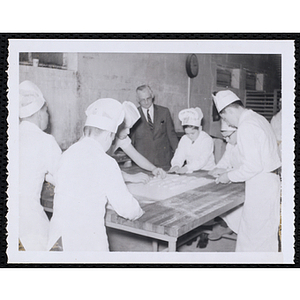 Members of the Tom Pappas Chefs' Club prepare dough in a kitchen