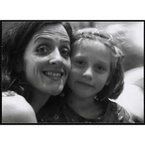 A woman and a girl pose for a head shot