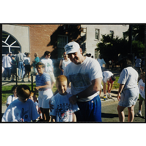 A man poses with two boys during the Battle of Bunker Hill Road Race