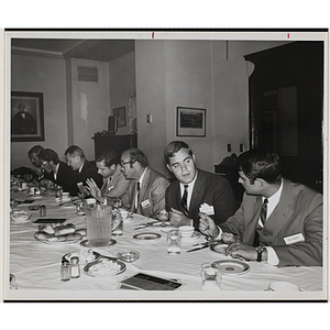 Committee members eat and converse at a Boys' Club event