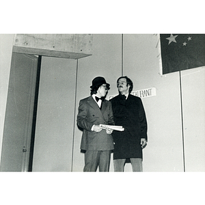 Two men performing a theatrical sketch onstage at the Josiah Quincy School about the normalization of U.S. and China relations