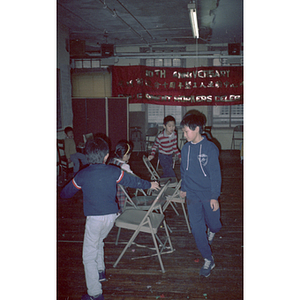 Children play musical chairs at a Garment Workers' Center celebration