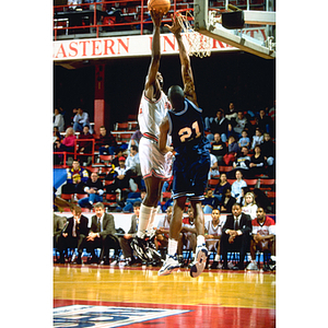 Northeastern's Deo Djossou attempts to score against a Maine opponent