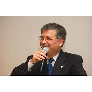 George Chryssis laughs into the microphone at The National Council Dinner