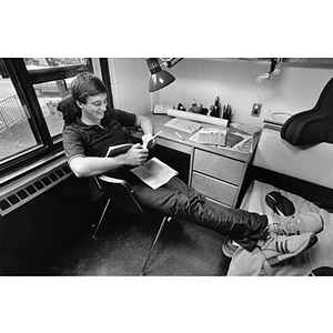 A student reads in his dorm room on move-in day