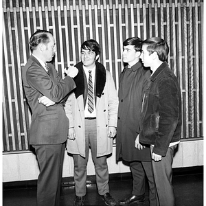 Four men converse at the College of Criminal Justice Open House