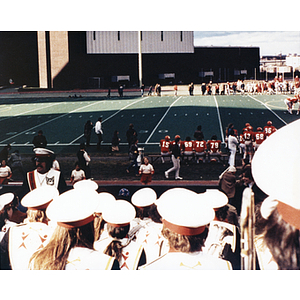 Members of the band watch a football game