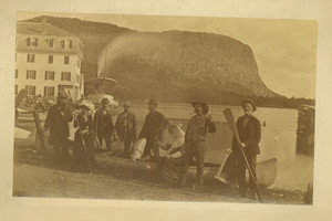 Men and women lined up in front of a canoe, Moosehead Lake, Maine, undated